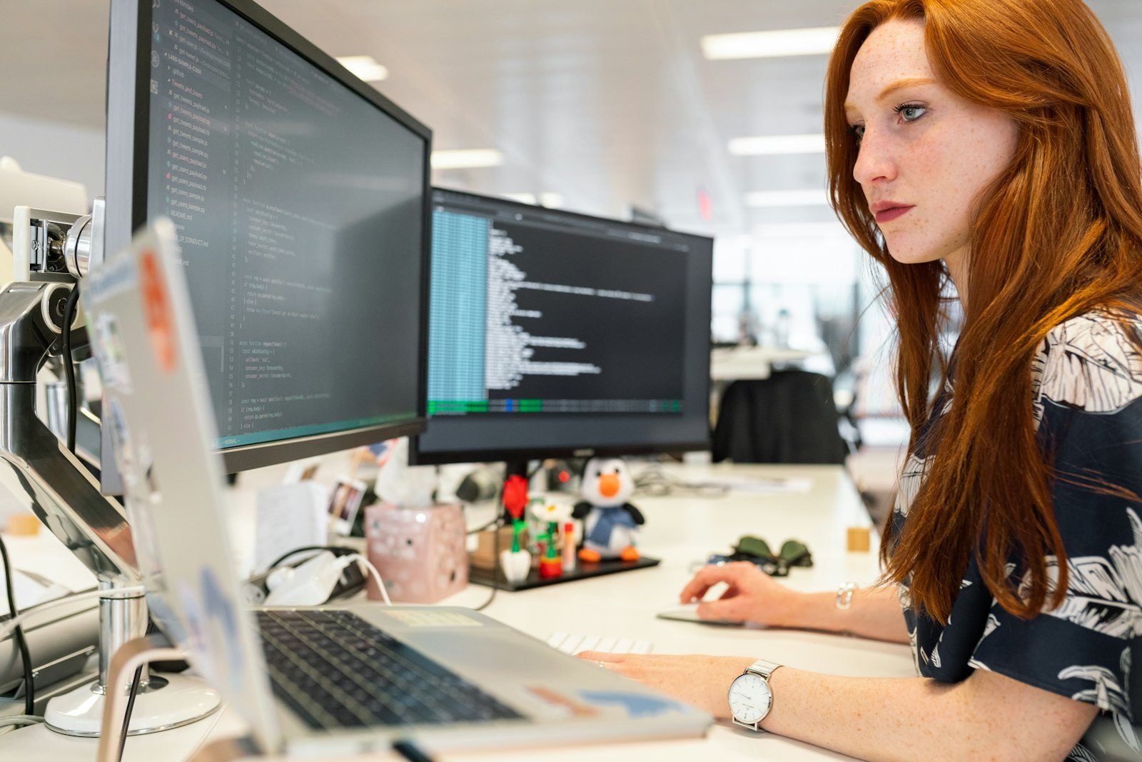 A data consultant working at her monitors