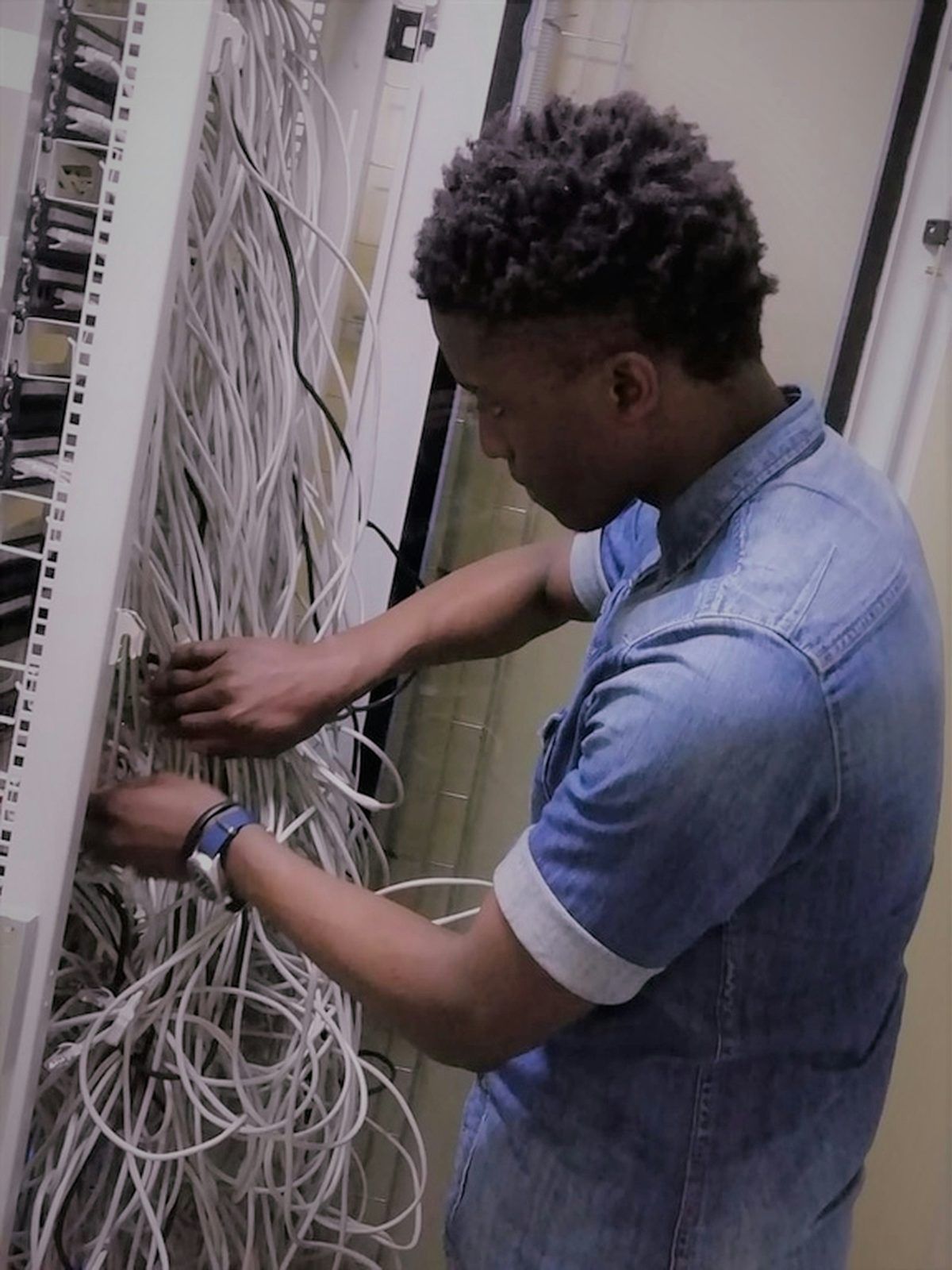 An infrastructure engineer cabling a server rack