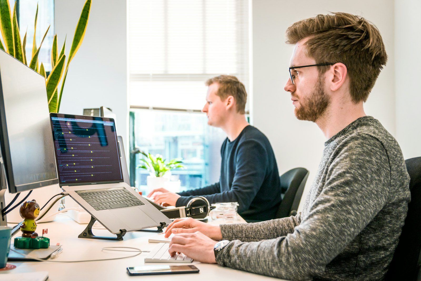 Two developers working at their screens